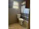 Bathroom featuring a toilet and a striped shower curtain under a window at 608 W 2Nd Pl, Mesa, AZ 85201