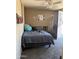 Bedroom featuring a gray comforter, ceiling fan, and door to the outside at 608 W 2Nd Pl, Mesa, AZ 85201