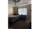 Bedroom featuring a bed with a gray comforter, ceiling fan, and natural light at 608 W 2Nd Pl, Mesa, AZ 85201