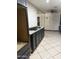 Kitchen view featuring dark cabinets, granite countertops, and tile flooring, needing light improvements at 608 W 2Nd Pl, Mesa, AZ 85201