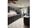 Well-equipped kitchen with dark cabinets, stainless steel fridge, and tile flooring, offering ample space at 608 W 2Nd Pl, Mesa, AZ 85201