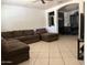 Comfortable living room with a large sectional sofa and an open archway leading to the dining area at 608 W 2Nd Pl, Mesa, AZ 85201