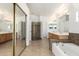 Primary bath with tub, separate shower, dual sinks, large mirror and decorative accents at 6510 S Hazelton Ln # 101, Tempe, AZ 85283