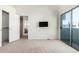Bedroom features an outdoor view, closet, a mounted television, and carpet at 6510 S Hazelton Ln # 101, Tempe, AZ 85283