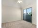 Bright bedroom with a ceiling fan and sliding doors to a balcony at 6510 S Hazelton Ln # 101, Tempe, AZ 85283