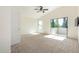 Spacious bedroom features a ceiling fan, balcony access, and carpet floors at 6510 S Hazelton Ln # 101, Tempe, AZ 85283