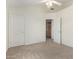 Neutral bedroom with carpeting and white trim; a doorway leads to closet or storage area at 6510 S Hazelton Ln # 101, Tempe, AZ 85283