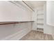 Walk-in closet with wood rod, shelving and carpeted floors at 6510 S Hazelton Ln # 101, Tempe, AZ 85283