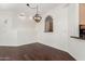 Open dining area featuring hardwood floors and views into the kitchen at 6510 S Hazelton Ln # 101, Tempe, AZ 85283