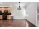 Cozy dining area featuring hardwood floors, black appliances, and large windows at 6510 S Hazelton Ln # 101, Tempe, AZ 85283