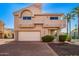 Charming two-story home featuring a two-car garage, manicured landscaping, and a gated entrance at 6510 S Hazelton Ln # 101, Tempe, AZ 85283