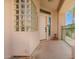 Inviting front porch with a unique glass block wall and a view of a palm tree at 6510 S Hazelton Ln # 101, Tempe, AZ 85283