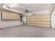 Spacious garage with epoxy flooring, storage cabinets and an automatic door at 6510 S Hazelton Ln # 101, Tempe, AZ 85283