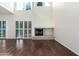 Bright living room with hardwood floors, a fireplace, and large windows that provide plenty of natural light at 6510 S Hazelton Ln # 101, Tempe, AZ 85283