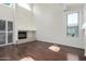 Bright living room featuring hardwood floors, a fireplace, and large windows that provide plenty of natural light at 6510 S Hazelton Ln # 101, Tempe, AZ 85283
