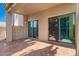 A cozy covered patio with tile flooring and sliding glass doors for indoor-outdoor living at 6510 S Hazelton Ln # 101, Tempe, AZ 85283