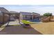 This backyard features a pool, a pergola, a fire pit, and artificial grass at 6623 S 23Rd Dr, Phoenix, AZ 85041