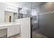 Bright bathroom featuring a glass-enclosed shower and double sinks at 6623 S 23Rd Dr, Phoenix, AZ 85041