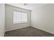This bedroom features carpet flooring and a window with blinds at 6623 S 23Rd Dr, Phoenix, AZ 85041