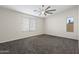 Spacious bedroom with plush carpeting and bright windows at 6623 S 23Rd Dr, Phoenix, AZ 85041