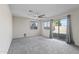 This bedroom features carpet flooring, a ceiling fan, and a sliding glass door at 6623 S 23Rd Dr, Phoenix, AZ 85041