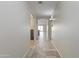 Inviting hallway with travertine tile flooring leading to bright living spaces within the home at 6623 S 23Rd Dr, Phoenix, AZ 85041