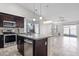 Contemporary kitchen open to the living area, boasting a granite island, and modern appliances at 6623 S 23Rd Dr, Phoenix, AZ 85041