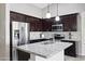 Updated kitchen with granite countertops, stainless steel appliances, and ample dark wood cabinetry at 6623 S 23Rd Dr, Phoenix, AZ 85041