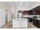 Modern kitchen featuring granite countertops, stainless steel appliances, and a stylish center island at 6623 S 23Rd Dr, Phoenix, AZ 85041
