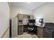 This office features a built-in desk, cabinets, shelving, an office chair, and a filing cabinet at 6623 S 23Rd Dr, Phoenix, AZ 85041