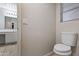 Toilet room featuring travertine floors and neutral paint at 6623 S 23Rd Dr, Phoenix, AZ 85041
