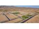 This bird's-eye shows a new community with spacious lots, green areas, and mountain views, ready for homeowners to move in at 6853 N 190Th Dr, Waddell, AZ 85355