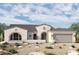 Charming single-story home boasts a neutral palette, desert landscaping, and a welcoming arched entry, embodying Southwestern elegance at 6853 N 190Th Dr, Waddell, AZ 85355