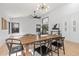 Bright dining room featuring a wooden table, modern lighting, and stylish decor at 6935 W Monte Lindo St, Glendale, AZ 85310