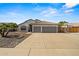 Beautiful stucco home features a tile roof, desert landscaping, and a spacious two-car garage at 6935 W Monte Lindo St, Glendale, AZ 85310