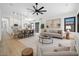 Open concept living room with dining area, kitchen, and large windows letting in natural light for an airy feel at 6935 W Monte Lindo St, Glendale, AZ 85310
