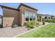 Exterior of home featuring a covered patio and landscaped backyard at 699 E Watermelon Ln, Queen Creek, AZ 85140