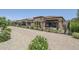 Beautiful backyard featuring desert landscaping, black metal fencing, and a covered patio area at 699 E Watermelon Ln, Queen Creek, AZ 85140