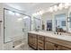Bathroom featuring double sinks and luxurious glass-enclosed shower at 699 E Watermelon Ln, Queen Creek, AZ 85140