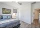 Bright bedroom features a ceiling fan, ensuite closet, neutral decor, and wood-look flooring at 699 E Watermelon Ln, Queen Creek, AZ 85140