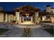 Grand community entrance with stone columns, exposed timber, and manicured landscaping at 699 E Watermelon Ln, Queen Creek, AZ 85140