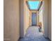 Covered entryway featuring stylish pavers, a gray front door, and a skylight for natural lighting at 699 E Watermelon Ln, Queen Creek, AZ 85140