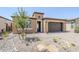 Attractive single-Gathering home with desert landscaping, a two car garage, and a covered front entrance at 699 E Watermelon Ln, Queen Creek, AZ 85140