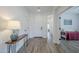 Bright foyer with wood floors, white walls, and views of the bedroom and hallway at 699 E Watermelon Ln, Queen Creek, AZ 85140