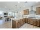 Open-concept kitchen with island, stainless steel hood, and view to the dining area at 699 E Watermelon Ln, Queen Creek, AZ 85140