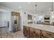 Kitchen island featuring stainless steel refrigerator and ample countertop space at 699 E Watermelon Ln, Queen Creek, AZ 85140