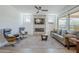 Cozy living room with a fireplace, ceiling fan, and comfortable seating at 699 E Watermelon Ln, Queen Creek, AZ 85140