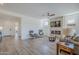 Spacious living room featuring a stone fireplace, hardwood floors, and lots of natural light at 699 E Watermelon Ln, Queen Creek, AZ 85140