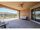 Covered patio with outdoor seating, brick pavers, and ceiling fan at 699 E Watermelon Ln, Queen Creek, AZ 85140