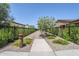 Community walking path surrounded by lush landscaping and decorative black metal fencing at 699 E Watermelon Ln, Queen Creek, AZ 85140